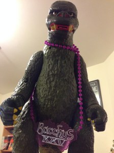 His right fist shoots off, which is cool, though my children and pets don't think so (Godzilla has good aim). The Bacchus bead is from Mardi Gras. Godzilla might like to party; you don't know.